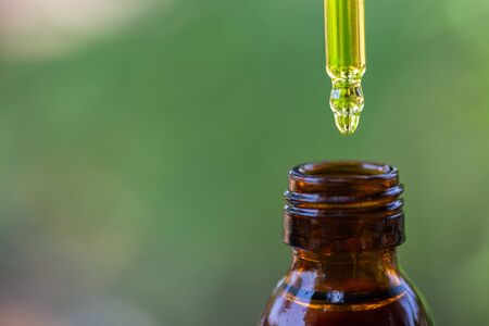 close up of droplet dosing a biological and ecological hemp plant herbal pharmaceutical cbd oil from...