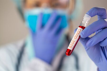 Doctor holding test tube with blood for 2019-nCoV analyzing. covid-19 virus, Coronavirus blood test Concept.の写真素材