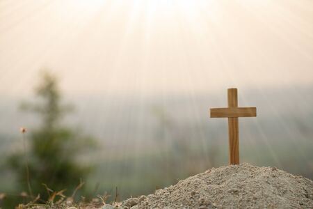 Religious concepts. Christian wooden cross on a background with dramatic lighting,  Jesus Christ...