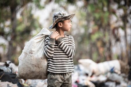 Poor children collect garbage for sale because of poverty, Junk recycle, Child labor, Poverty concept, human trafficking, World Environment Day,の写真素材