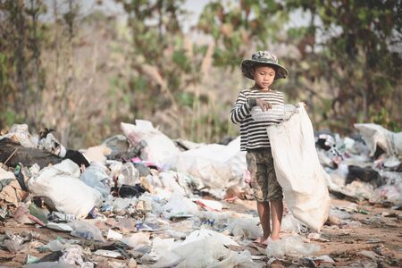 Poor children collect garbage for sale because of poverty, Junk recycle, Child labor, Poverty concept, human trafficking, World Environment Day,の写真素材