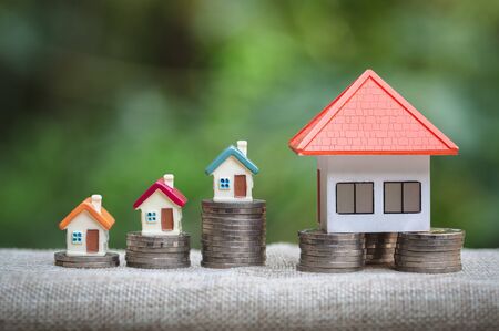 Mini house on green nature background,   Mortgage concept, Real estate investment, Real estate business success.の写真素材