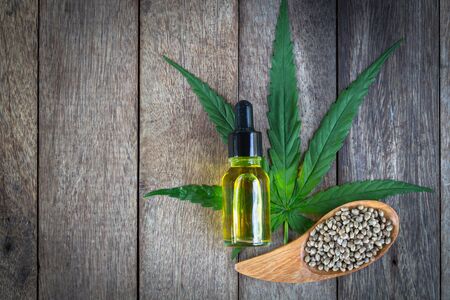 CBD cannabis oil. hemp product,  Hand holding bottle of Cannabis oil in pipette,  medical marijuana concept.の写真素材