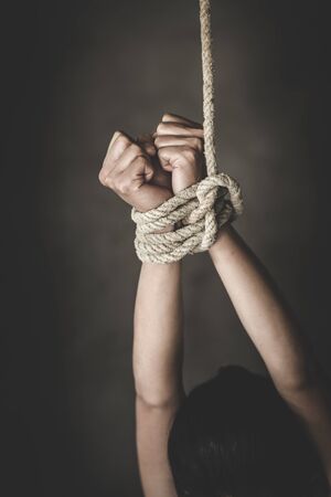 woman hands bound prisoner in room, hands bound, woman's hand tied with a rope, Detainee was detain...