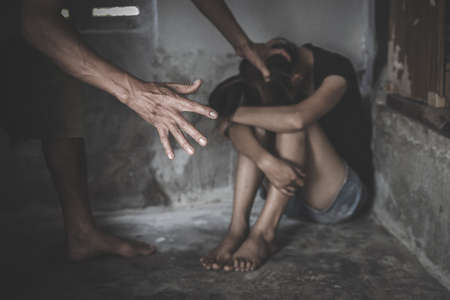 Scared abuse victim being attacked by a man, domestic violence, Sexual harassment and rape.の写真素材