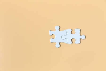 piece of  White jigsaw puzzle On the Yellow background . teamwork concept.  symbol of association and connection. business strategy.の写真素材
