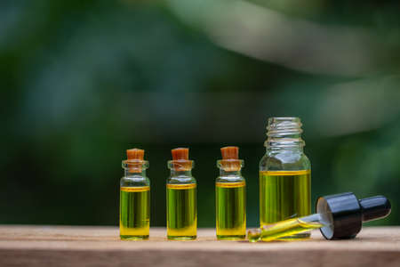 Glass bottles containing  hemp oil,  drugs extracted CBD Cannabis Oil  of researchers or medical team. Herbal alternative medicine.の写真素材