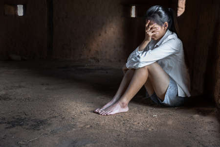 Young depressed woman, domestic and rape violence,beaten and raped sitting in the corner,  Copy space.  International Women's Dayの写真素材