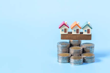 Mini house on stack of coins,Money and house,  Mortgage, Savings money for buy house and loan to business investment for real estate concept. Invesment and Risk Management.の写真素材