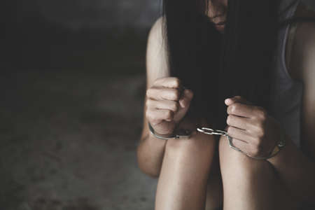 woman hands in handcuffs, human trafficking Concept, stop violence against women and human trafficking,  international women's day.の写真素材