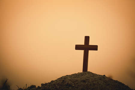 Silhouette of crucifix cross at sunset time with holy and light background.の写真素材