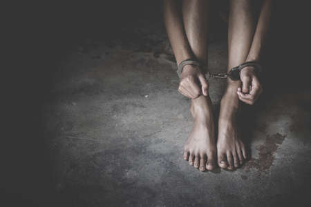 woman hands in handcuffs, human trafficking Concept, stop violence against women, Human rights violations.の写真素材