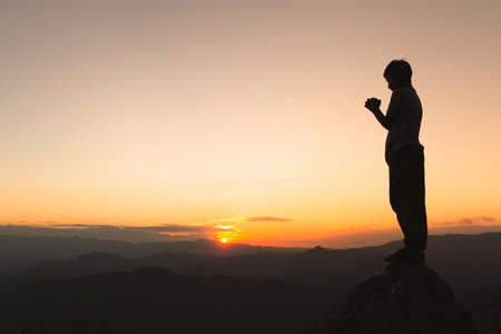 Religious Christian Adolescent boy praying over Bible indoors, Religious concepts. Religious beliefs...