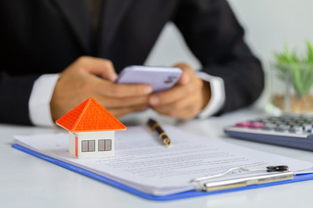 Home sales brokers are offering home sales ,Model house on the front desk. Real estate and residential concepts, house tradingの写真素材