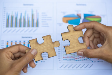 Two hands of businessman to connect couple puzzle piece. symbol of association and connection....