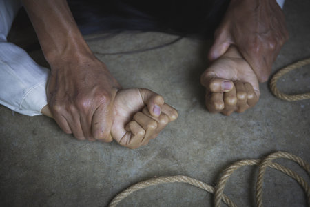 Man hands holding a woman hands for rape and sexual abuse concept. Stop sexual harassment and...