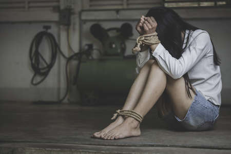 hopeless man hands tied together with rope, human trafficking, Stop abusing violence.の写真素材