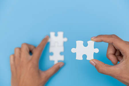 Jigsaw connection, Jigsaw puzzle in the hand of a businessman,  Business team assembling Jigsaw...