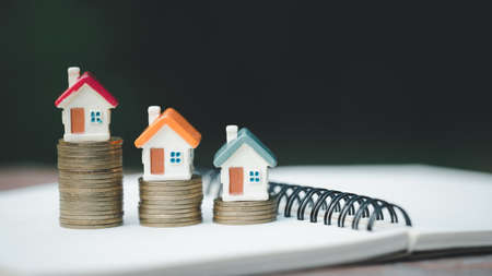 Mini house on stack of coins,Money and house,  Mortgage, Savings money for buy house and loan to...
