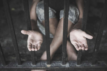 The child was locked in a steel cage, Violence against children, Domestic violence, Stop human trafficking  Concept, stop violence against Women, international women's dayの写真素材