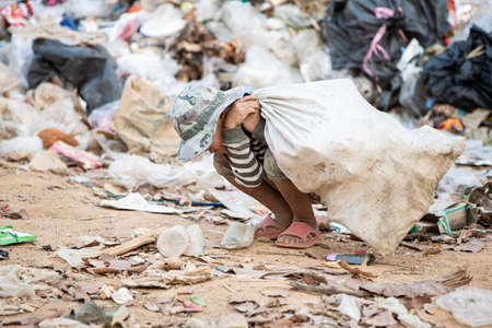 Children find junk for sale and recycle them in landfills, the lives and lifestyles of the poor, Child labor, Poverty and Environment Conceptsの写真素材