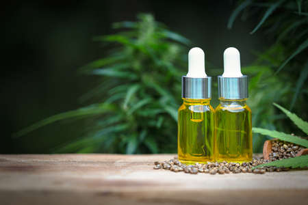 CBD oil hemp products, cannabis extract oil on a wooden table, Medical marijuana.の写真素材