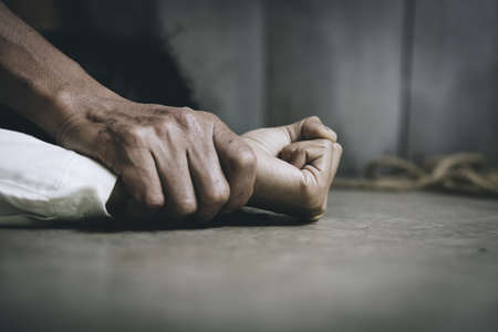 Close up of man hands holding a woman hands for rape and sexual abuse concept, Wound domestic violence rape, sexual assault, stop violence against women, human trafficking.の写真素材