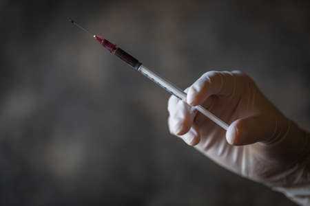 syringe for injection with medicine in hand.