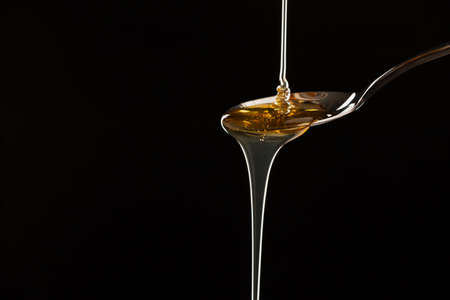 Pouring hemp oil into spoon.の写真素材