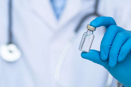 Coronavirus Vaccine concept in hand of doctor vaccine jar.の写真素材
