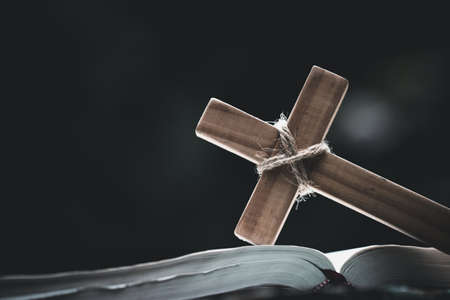 Closeup of  wooden christian cross  on Bible,  god, Wooden cross of Jesus.の写真素材