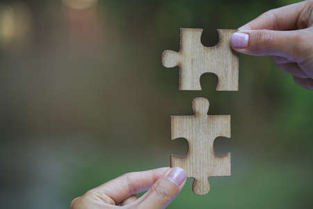 Jigsaw connection, Jigsaw puzzle in the hand of a businessman,  Business team assembling Jigsaw...