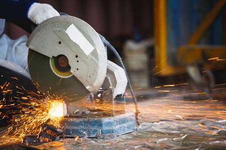 Cutting of a steel with splashes of sparks,  Metal processing with angle grinder. Sparks in metalworking.の写真素材