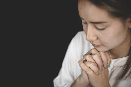 Interlocking hands praying for God's blessings. The idea of praying to the Lord with patience and steadfastness.の写真素材