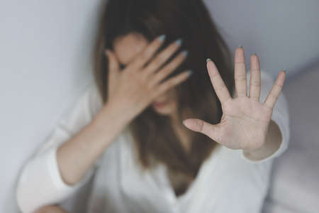 woman raising her hand stop sexual harassment anti human trafficking stop violence against women international women's day.の写真素材