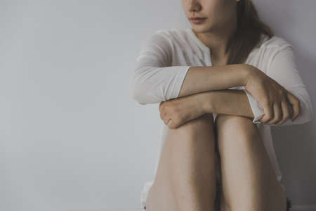 Women sitting on the floor crying with depression, Depressed woman sitting on ground, family...