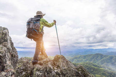 climber standing on a rock on the mountain.の写真素材