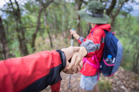 Couple of hikers with backpacks looking over mountains view. Hiking and leisure themeの写真素材