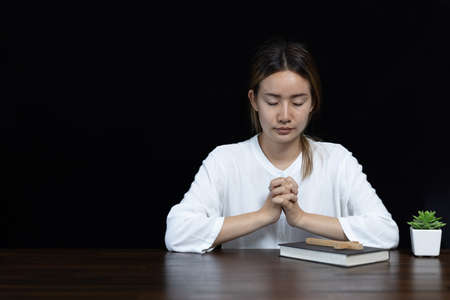 Young woman praying with  hand,  prayer concept for faith, spirituality and religionの写真素材