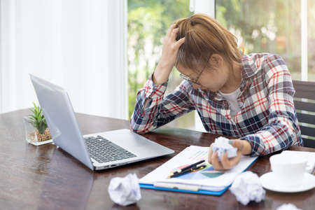 Women are stressed due to work failures, Business failure concept, Stressed businessman with head in...