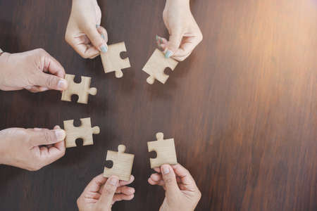 Jigsaw connection, Jigsaw puzzle in the hand of a businessman,  Business team assembling Jigsaw...
