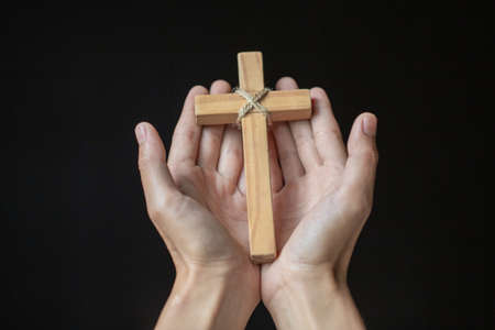 Human hands holding a cross holy and prayed for blessings from God,  Amour Worship God concept. -...