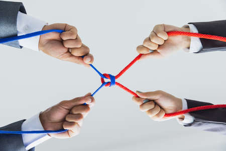 Hands of people pulling the rope, cooperation concept, Concept of business team using a rope as an...