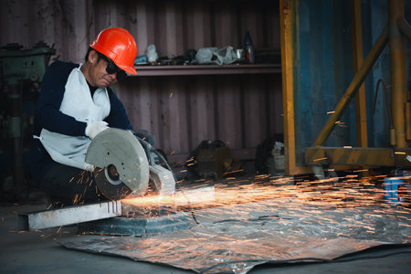 Cutting of a steel with splashes of sparks  in the industrial shop.の写真素材