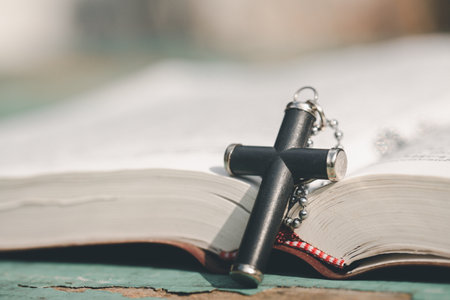 Closeup of  wooden christian cross  on Bible,  god, Wooden cross of Jesus.の写真素材