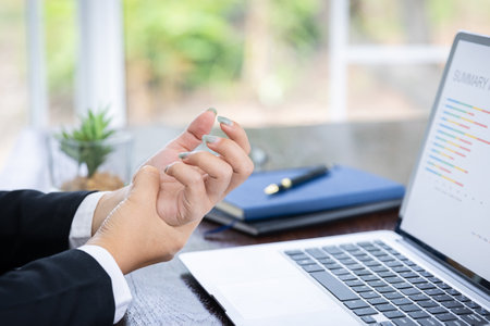 Hand of young women there is pain in the hands caused by use computer . causes his fingers to lock and he is press point pain.の写真素材