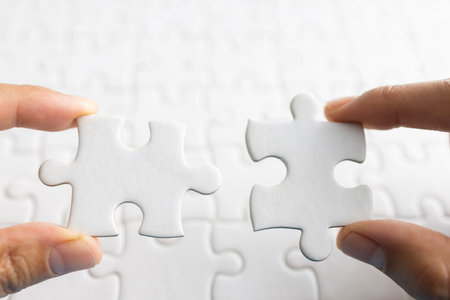 Closeup hand of man connecting jigsaw puzzle with sunlight effect, Business solutions, success and strategy conceptの写真素材
