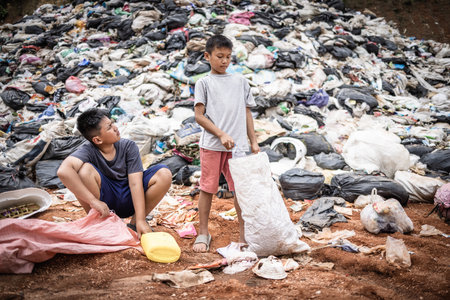 Children find junk for sale and recycle them in landfills, the lives and lifestyles of the poor, Child labor, Poverty and Environment Conceptsの写真素材