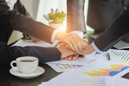 Business people put their hands together unity and teamwork concept Job success.の写真素材