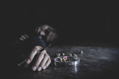 Drug addict young woman with syringe in action, Drug abuse concept, Stop drug addiction concept International Day.の写真素材